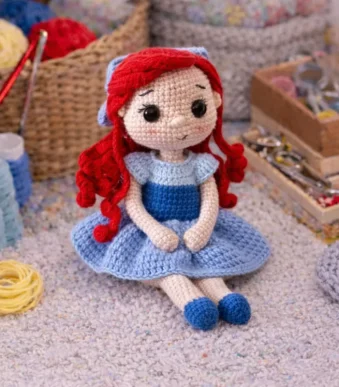 Little Mermaid crochet amigurumi doll with red curly hair and blue dress